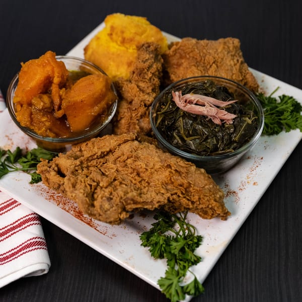 Detroit Soul's fried chicken, cornbread, candied yams, and collard greens with pulled pork.