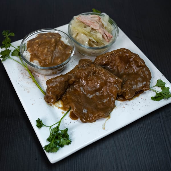 Detroit Soul's smothered pork chops with rice and gravy, and a side of cabbage.